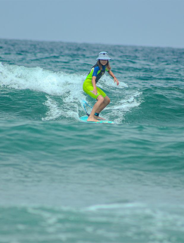 Surfeuse glissant sur une vague turquoise